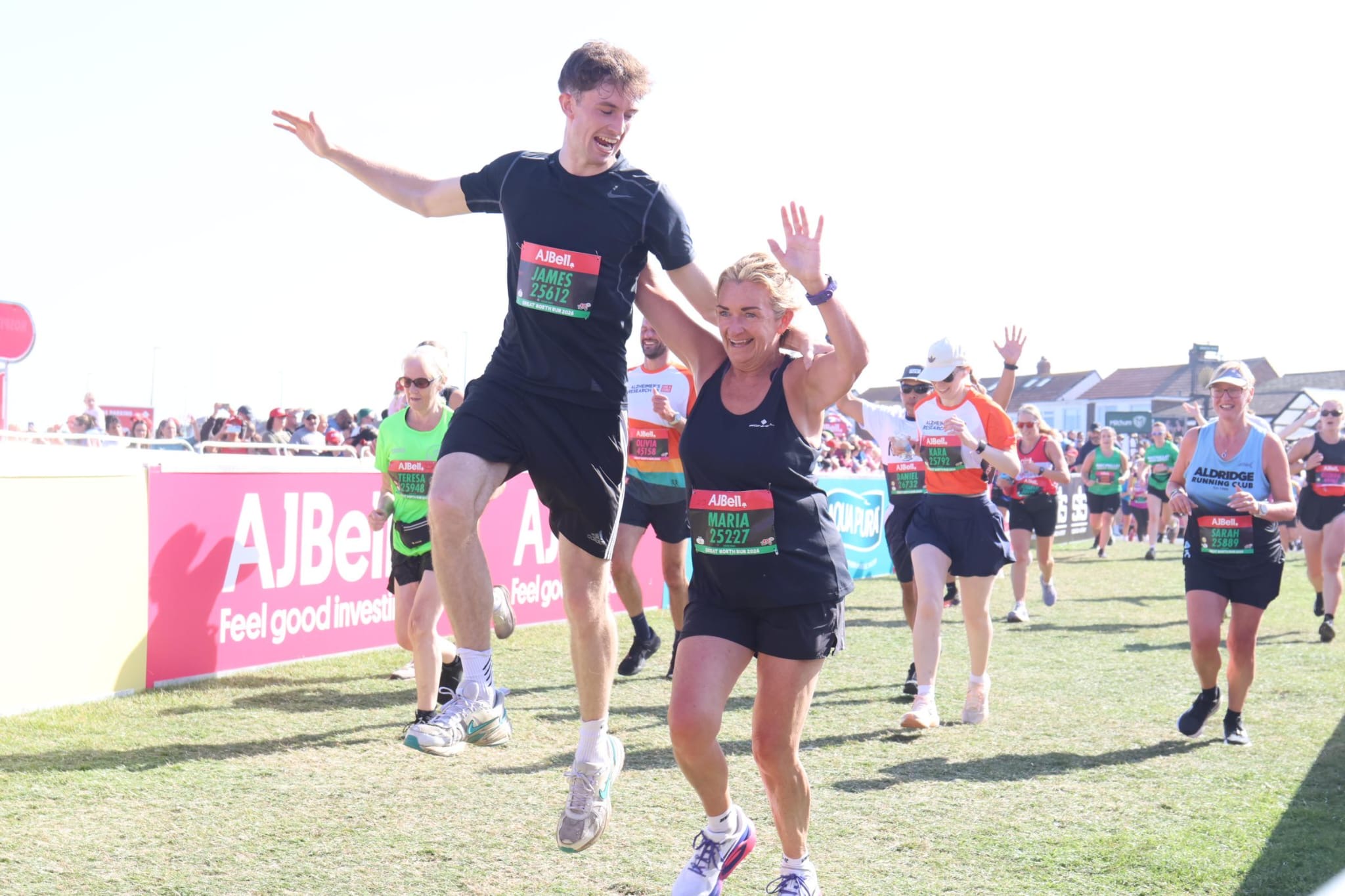 James and his mum celebrating as they complete the Great North Run together